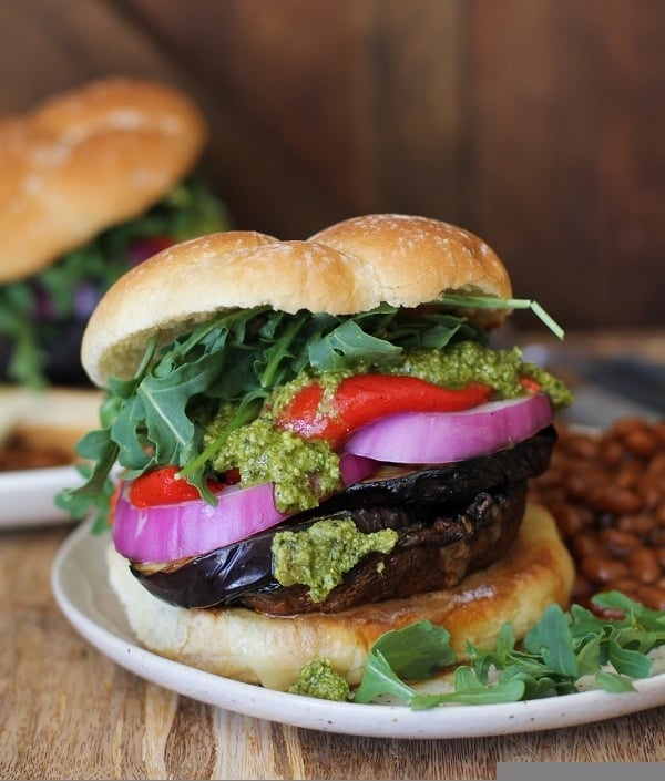 The Ultimate Grilled Portobello Burger with grilled eggplant, roasted red peppers, red onion, arugula, and pesto sauce | TheRoastedRoot.net #healthy #vegetarian #recipe