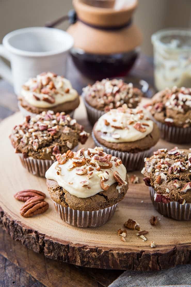 Wooden block with finished gingerbread muffins on top.
