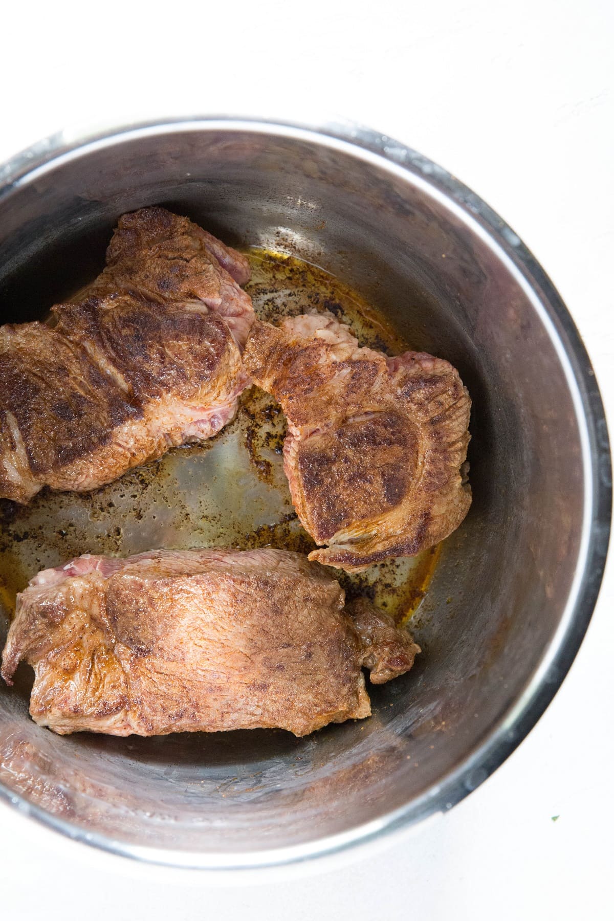 Seared beef chunks in an Instant Pot.
