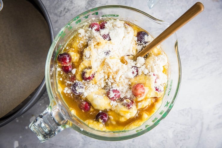 Measuring cup with cake ingredients being stirred together