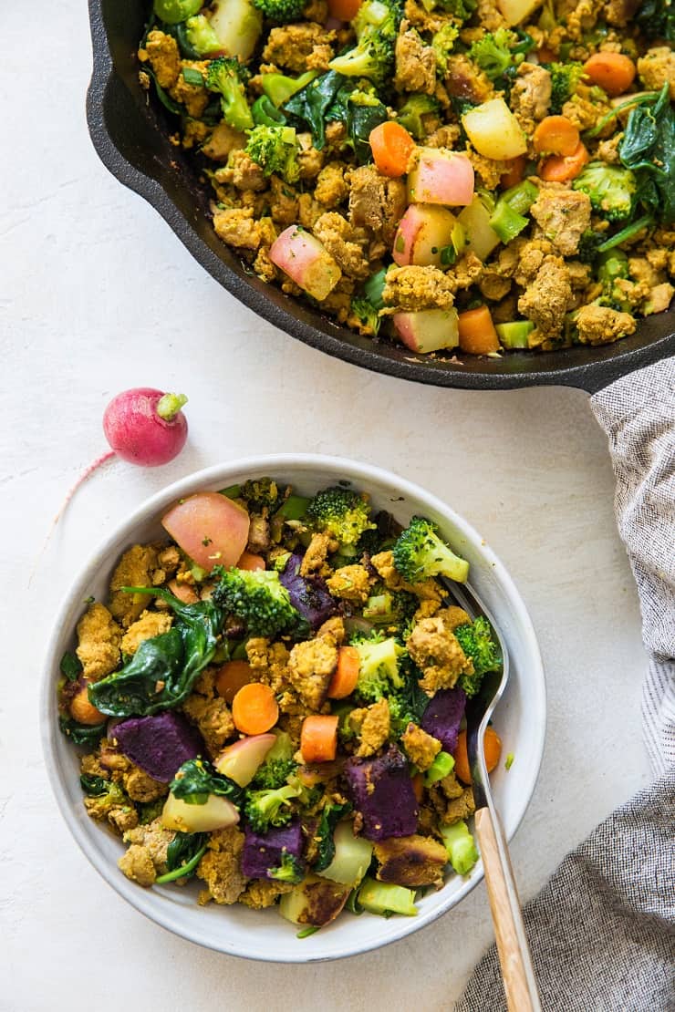 Bowl of ground meat and vegetables with a skillet with the rest of the batch to the side.