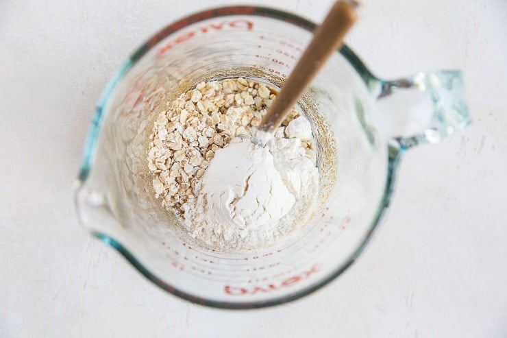 Ingredients for oatmeal cookie in a measuring cup