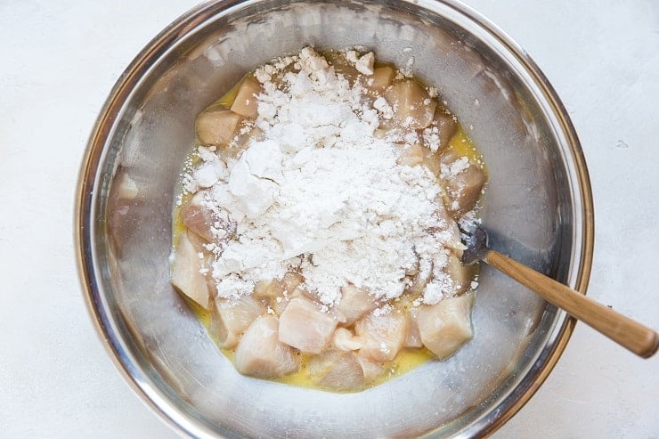 chopped chicken in beaten egg with flour