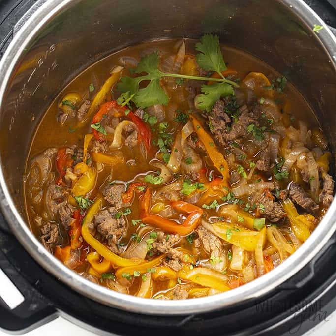 Instant Pot Steak Fajitas from Wholesome Yum - EASY Instant Pot steak fajitas are a delicious and healthy dinner. These steak fajitas in the Instant Pot take just 5 minutes to prep + 7 minutes to cook.ย ย