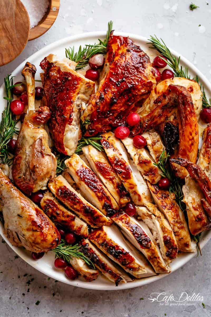 Garlic Herb Butter Roast Turkey from Cafe Delites - ย Garlic herb butter roast turkey recipe (without a brine!) is succulent and tender on the inside with a golden, buttery skin and so much flavor! Dried out breasts and meat are a thing of the past with this perfect Turkey Recipe. Slathered with a garlic herb butter then oven roasted to get the most perfect, juicy meat and golden brown skin.