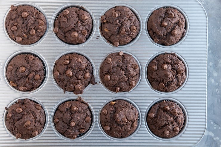 baked chocolate banana muffins in a muffin tray