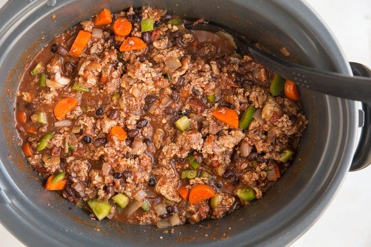 Add the sautéed onion and meat to the crock pot