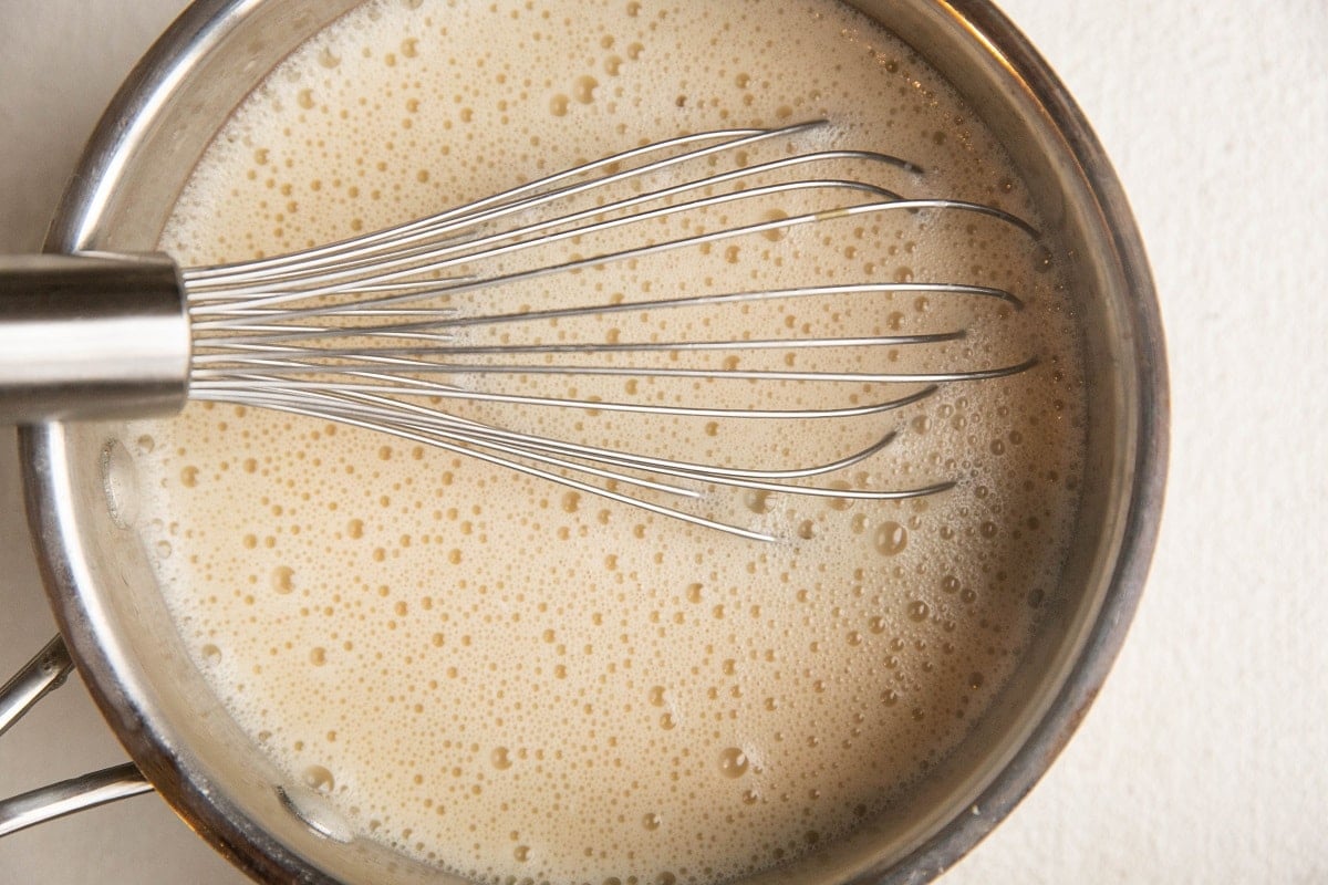 Custard mixture in a saucepan for bread pudding