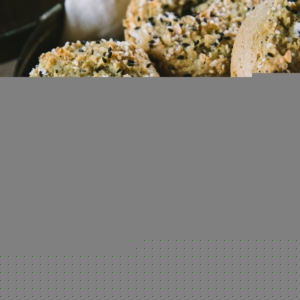 Basket full of almond flour bagels with a linen inside, ready to eat.