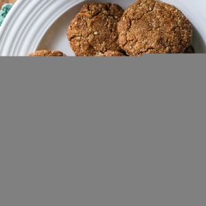 White plate of gluten free gingerbread cookies made with almond flour. Fresh out of the oven and ready to eat.
