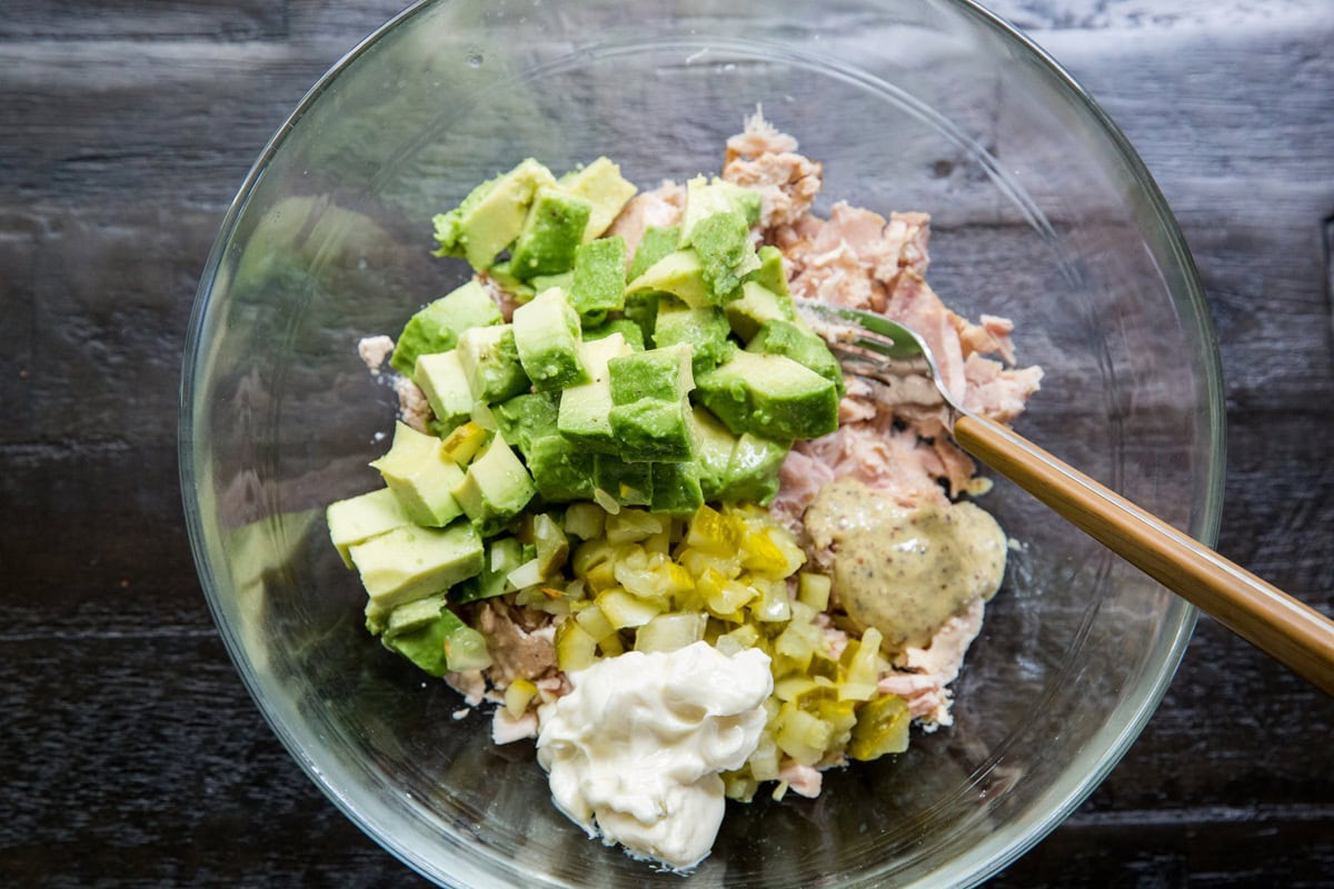 Ingredients for avocado tuna salad in a mixing bowl to make tuna fish salad.