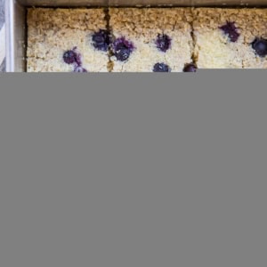 Baking dish with sliced blueberry baked oatmeal, ready to eat.