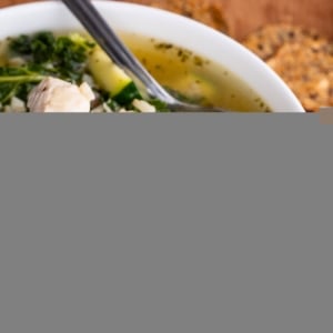 Big bowl of chicken soup with rice and kale