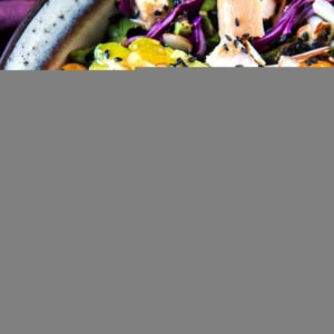 Healthy Chinese Chicken Salad in a large bowl, close up on the fresh vegetables and avocado. Ready to serve.