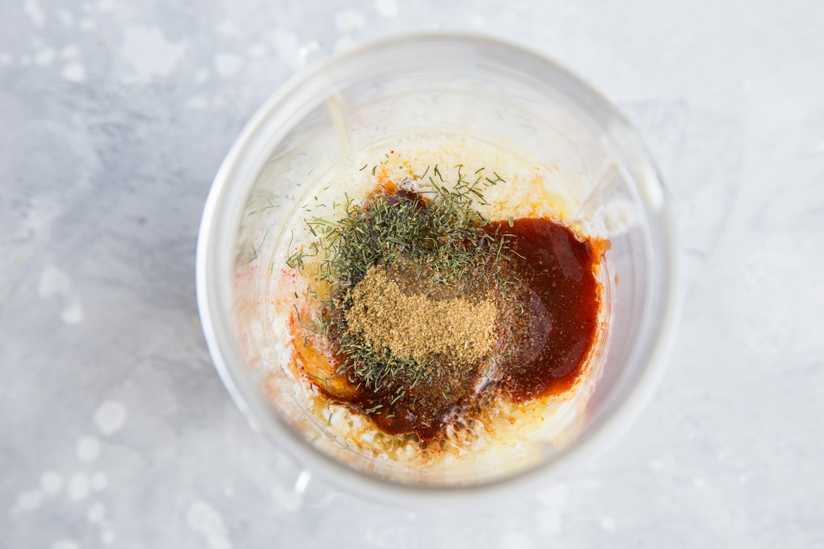 Small blender full of ingredients for chipotle dipping sauce, ready to be blended up.