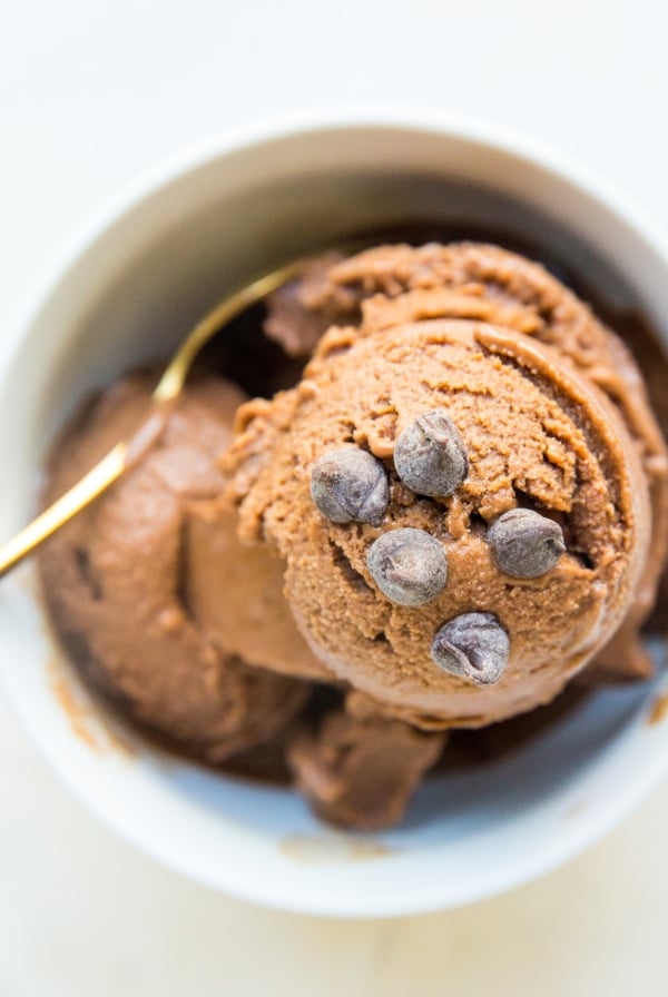 White bowl full of chocolate banana ice cream with chocolate chips sprinkled on top. Ready to serve!