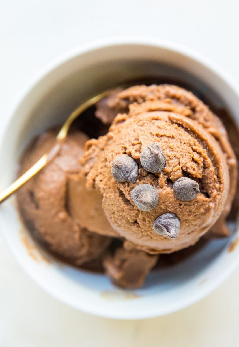 White bowl full of chocolate banana ice cream with chocolate chips sprinkled on top. Ready to serve!
