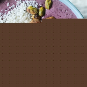 Acai bowl with walnuts, pistachios, sliced apples, greek yogurt