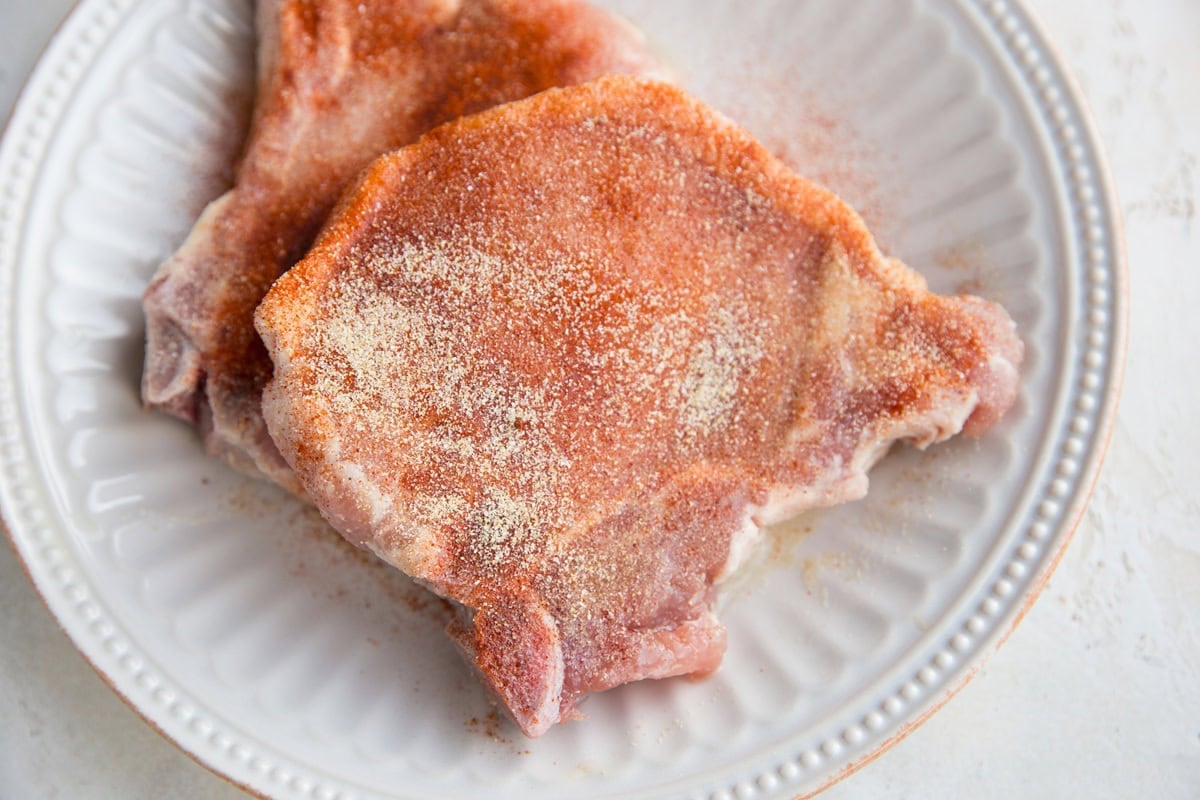 Sprinkle the pork chops with seasonings