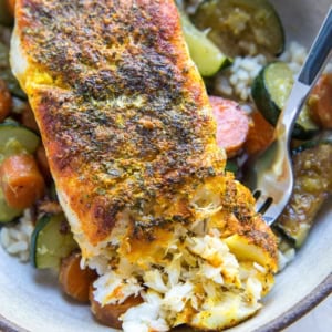 Low-fat Baked Cod with turmeric and paprika in a bowl with rice and veggies.