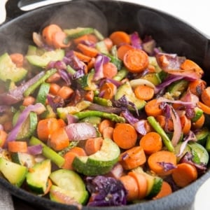 Easy Amazing Sautéed Veggies in a cast iron skillet, ready to be served. Sauteed veggies are the perfect side dish to any meal.