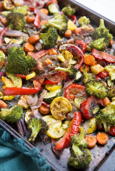 Garlic Herb Roasted Vegetables on a large rimmed sheet pan, fresh out of the oven.