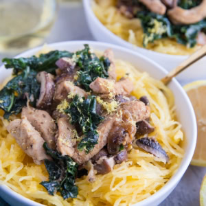 Chicken Garlic Spaghetti Squash with Kale and Mushrooms in two white bowls, ready to serve.