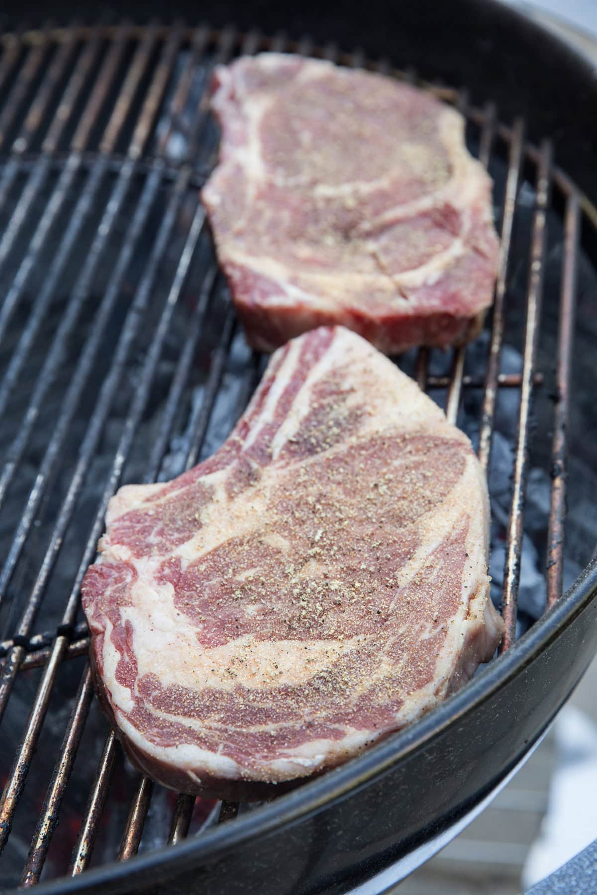 Place seasoned steaks on the grill