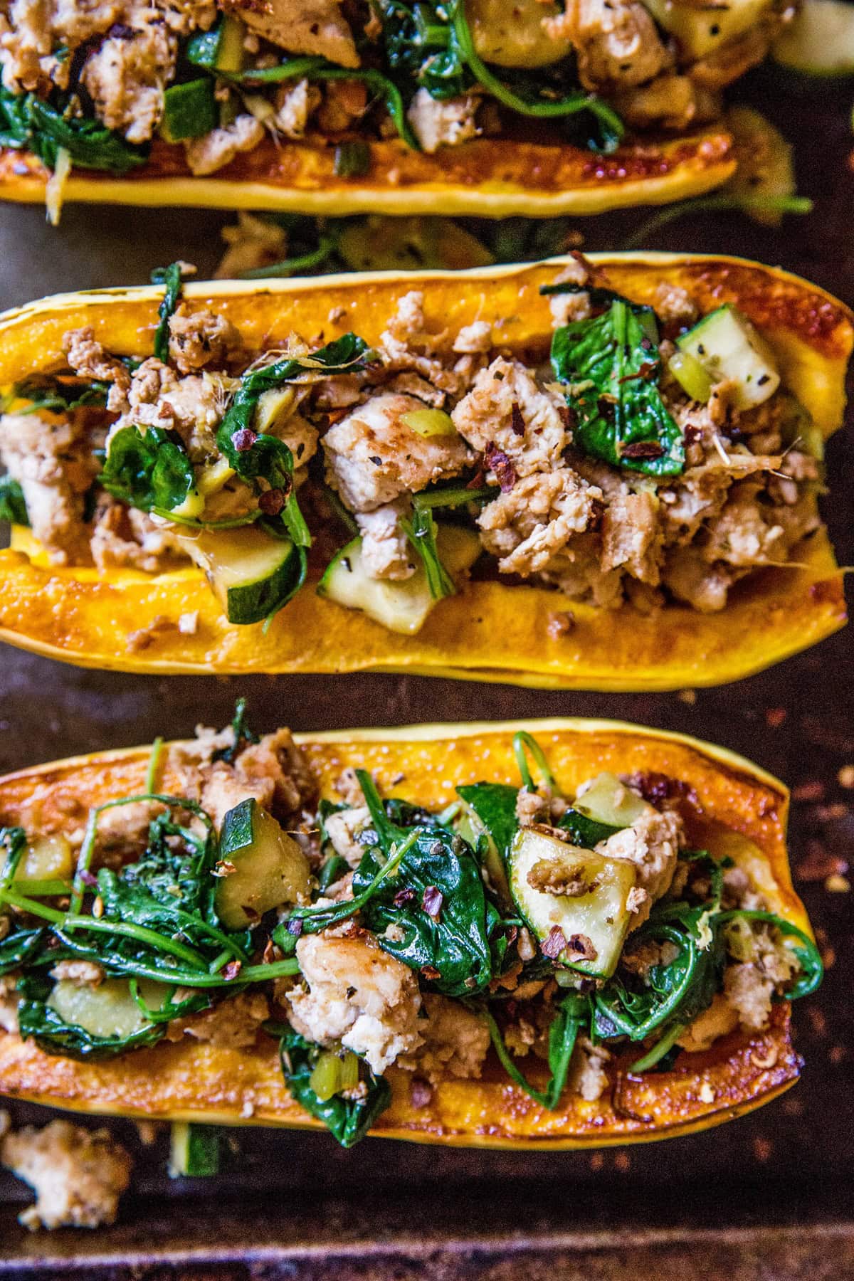 Ground Turkey Stuffed Delicata Squash on a baking sheet fresh out of the oven.