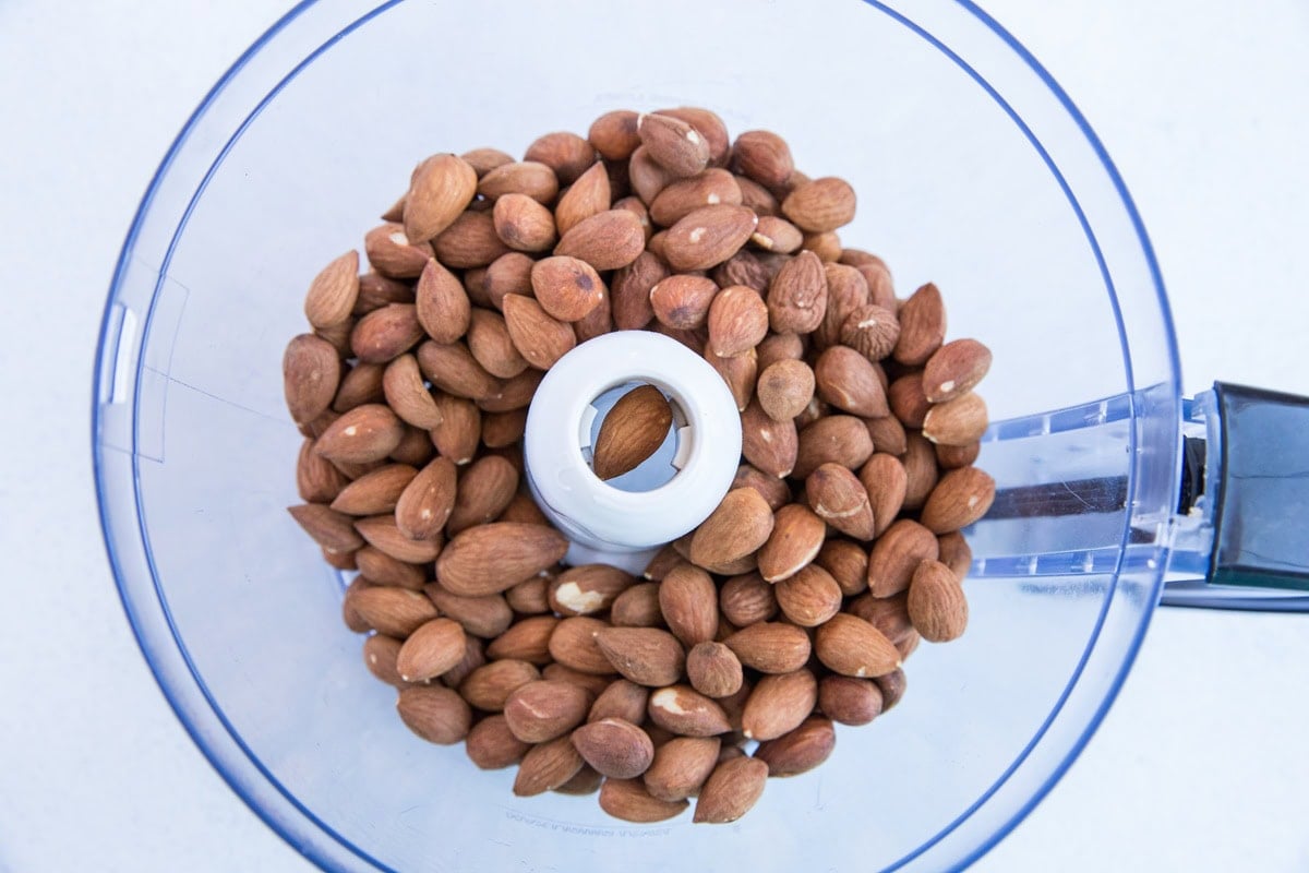 Almonds in a food processor to make almond butter.