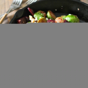 Cast iron skillet of sauteed brussel sprouts and beets, ready to serve.
