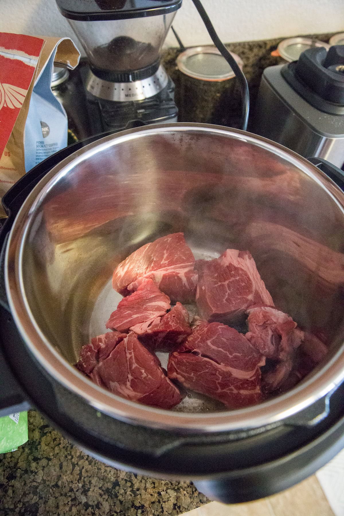 Big hunks of beef searing in the Instant Pot