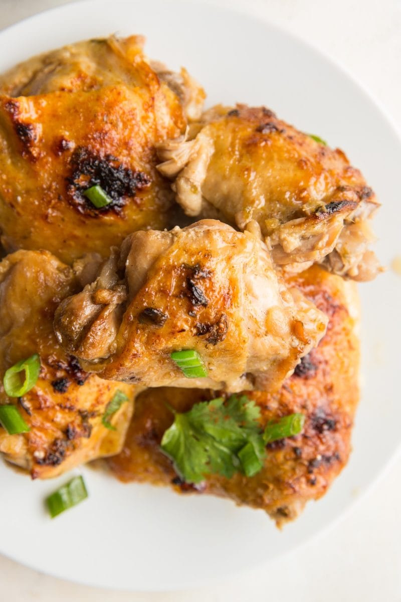 White plate full of cooked jerk chicken