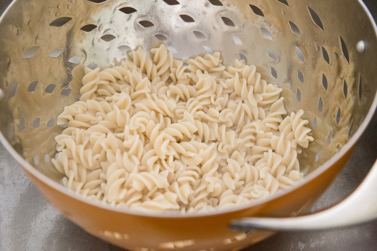 Cooked spiral noodles in a colander. Drained and ready to use in a pasta salad recipe.