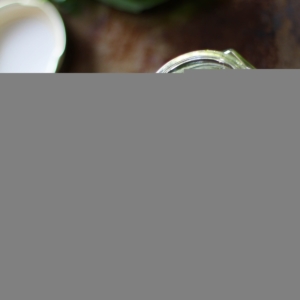 Kale Pesto in a jar with walnuts to the side.