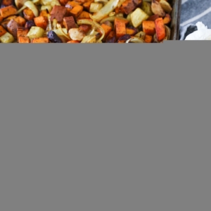 Baking sheet with roasted vegetables spread over the full surface. Fresh out of the oven and ready to serve.
