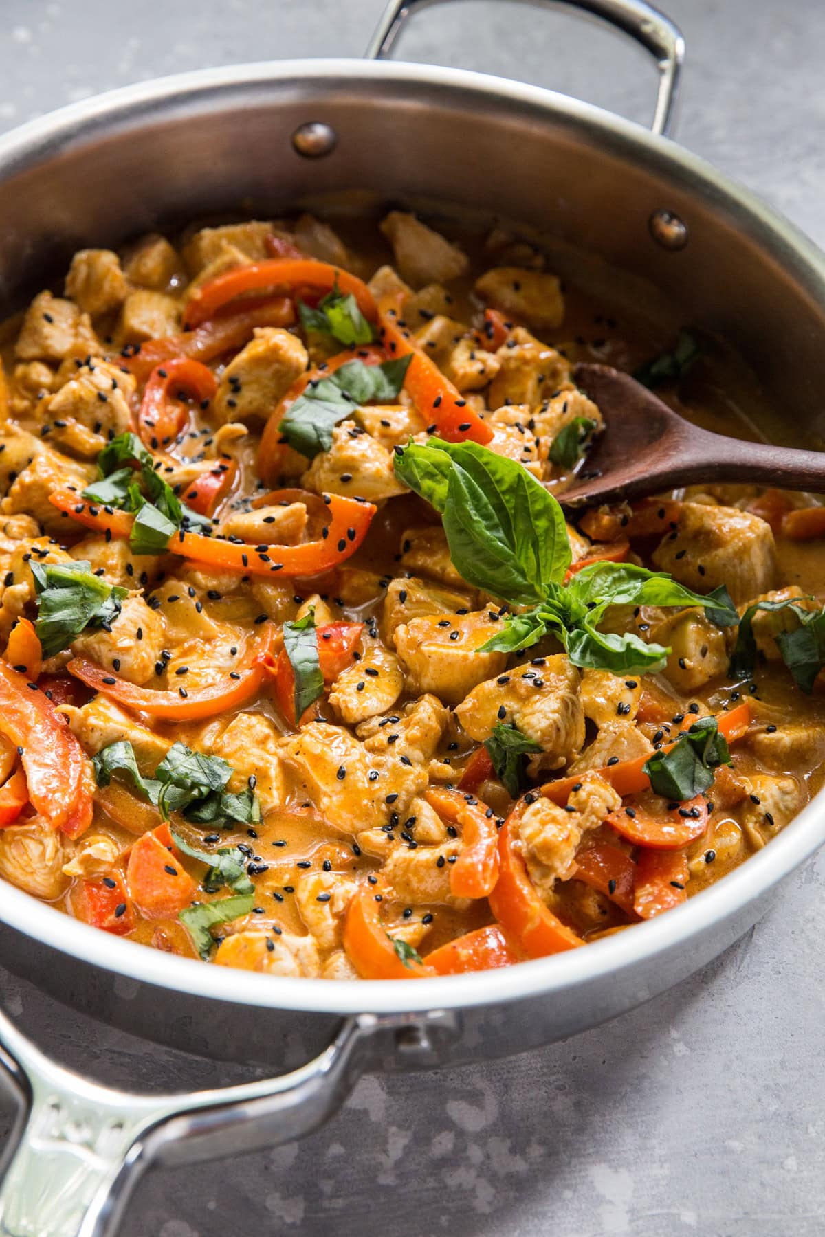 Large stainless steel skillet full of panang curry, ready to serve.