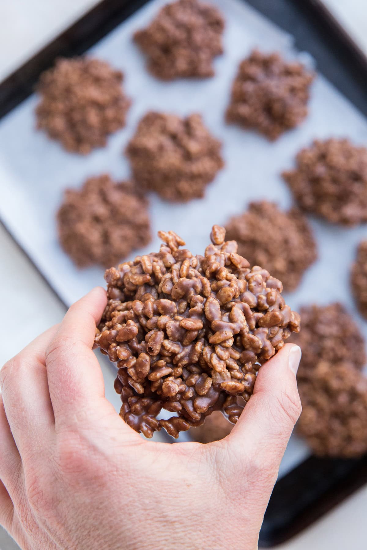 Hand holding a rice krispie cookie