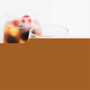 Pineapple Rosé Sangria in a glass with fresh fruit and a white napkin
