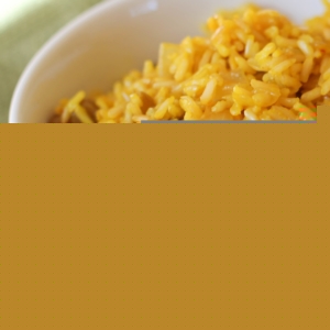 Big bowl full of saffron rice, ready to serve with a main dish.