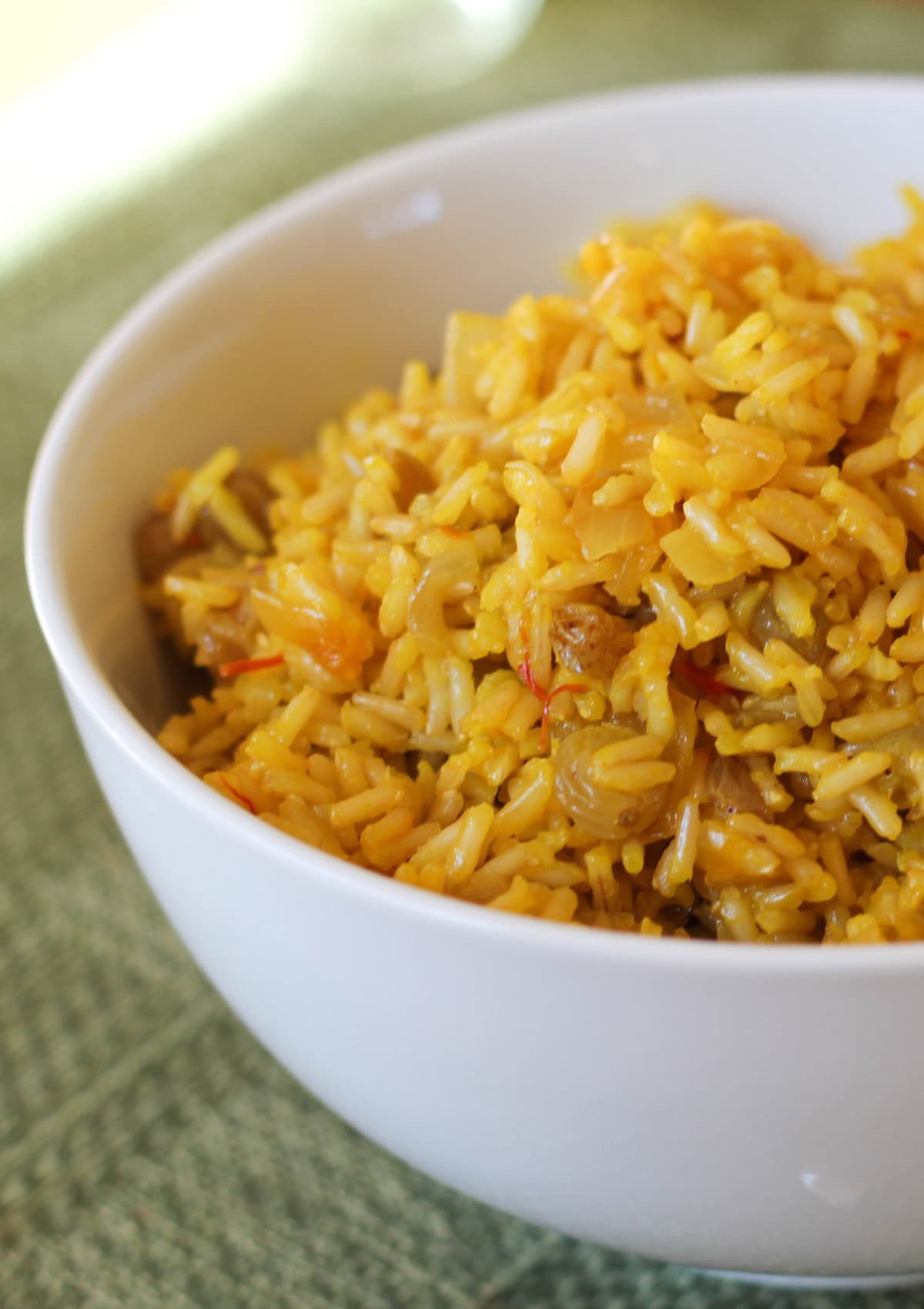 Big bowl full of saffron rice, ready to serve with a main dish.