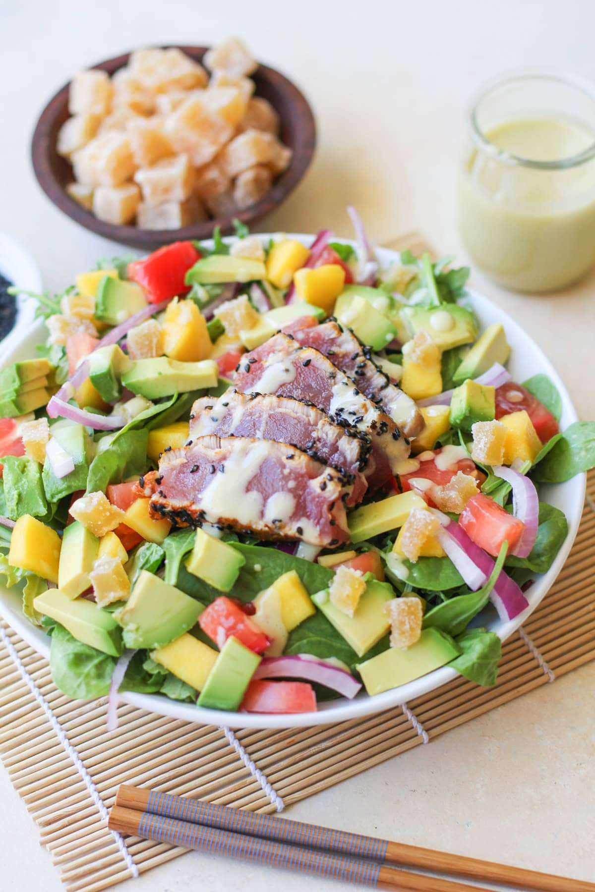 Seared Ahi Salad with Creamy Wasabi Dressing in a big bowl with chopsticks to the side and the rest of the creamy wasabi dressing in the background.