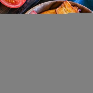 Cuban shredded beef bowl with roasted potatoes, shredded beef, plantains, and fresh tomatoes.
