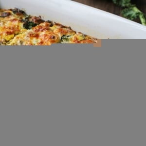 Sweet potato and sausage egg casserole in a baking dish with a piece missing, fresh out of the oven.