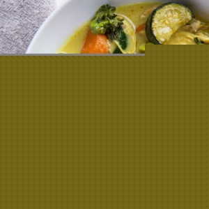 Big bowl of curry for one! Chicken yellow curry with vegetables and brown rice in a large bowl.