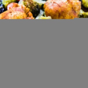 Turmeric Chicken Sheet Pan Dinner with vegetables and seasonings.