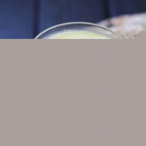 Glass of turmeric lassi with a napkin