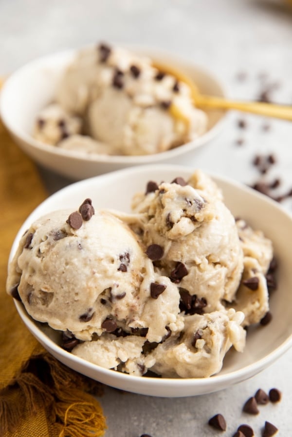 Two white bowls of cookie dough ice cream.