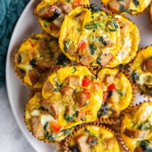 Sausage egg muffins on a white plate, ready to serve.