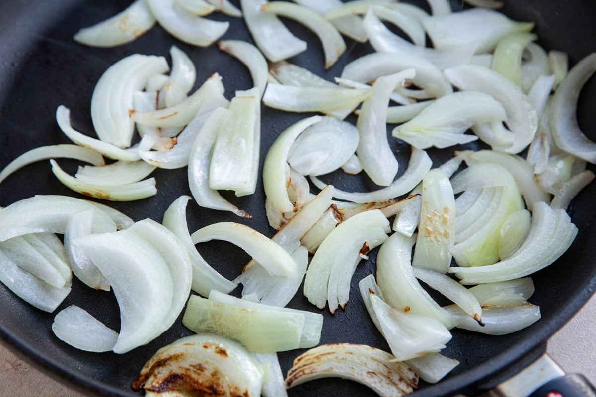 Onions cooking in a skillet.